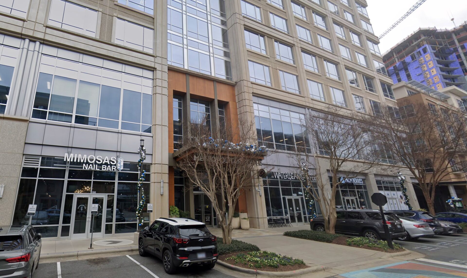 Charlotte ascendly marketing office building with shops and cars.