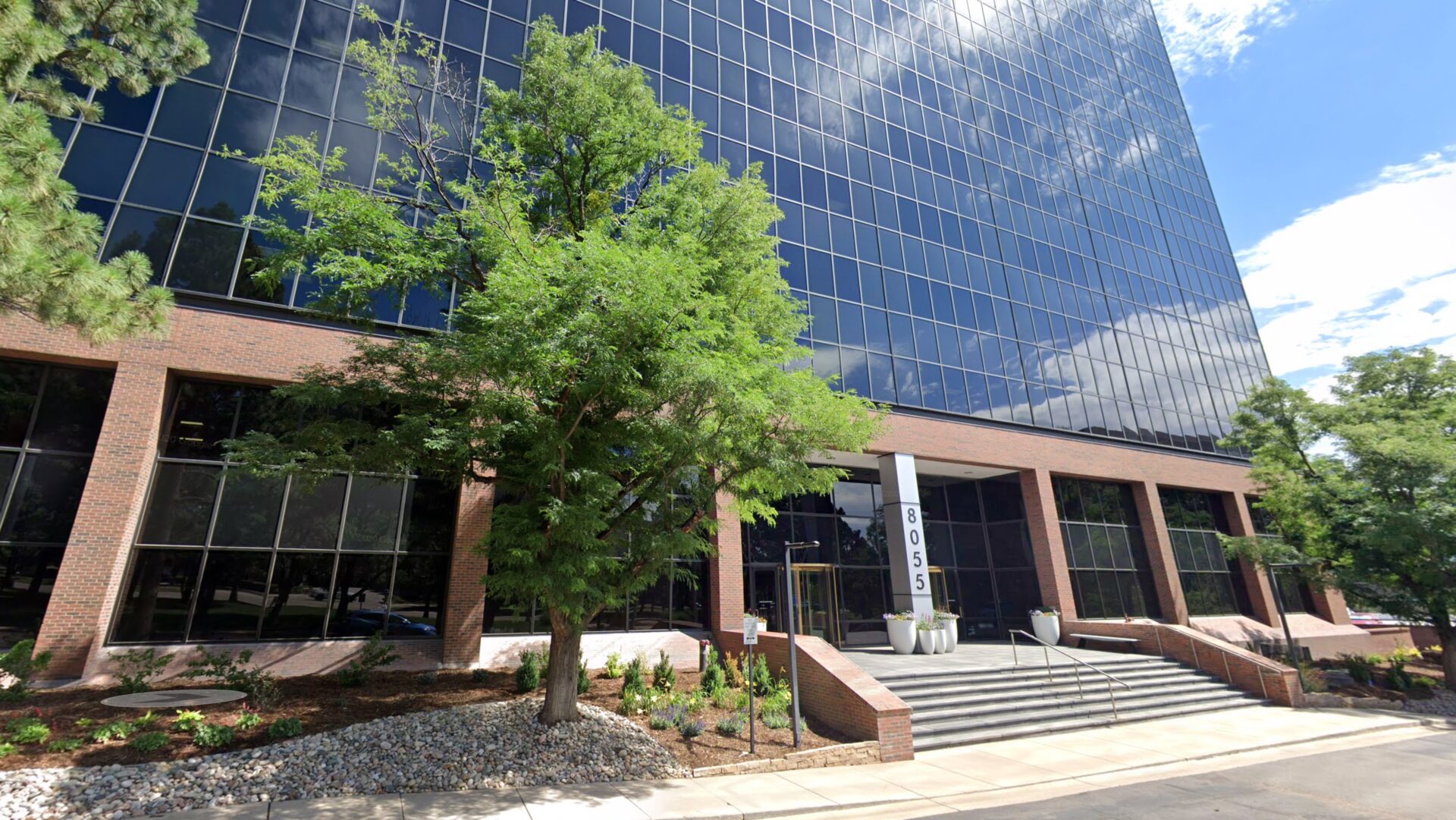 Denver ascendly marketing office building with landscaping.
