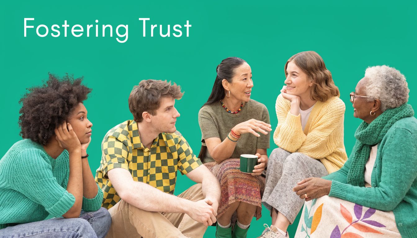 A diverse group of four people sitting together in a circle, engaged in conversation on a green background.