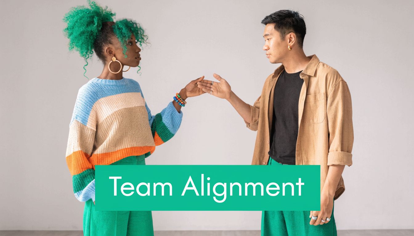 A man and a woman in colorful casual clothing reaching out to touch fingers in team alignment.