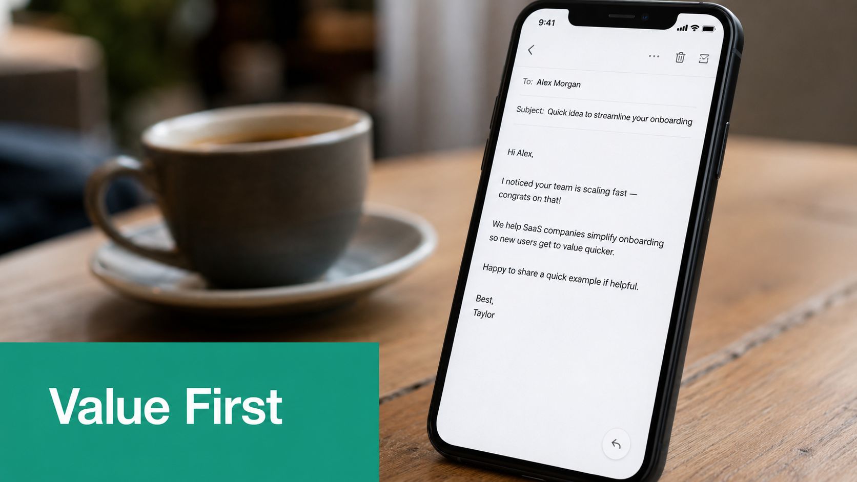 A smartphone on a table displays a short professional cold email about streamlining customer onboarding processes.