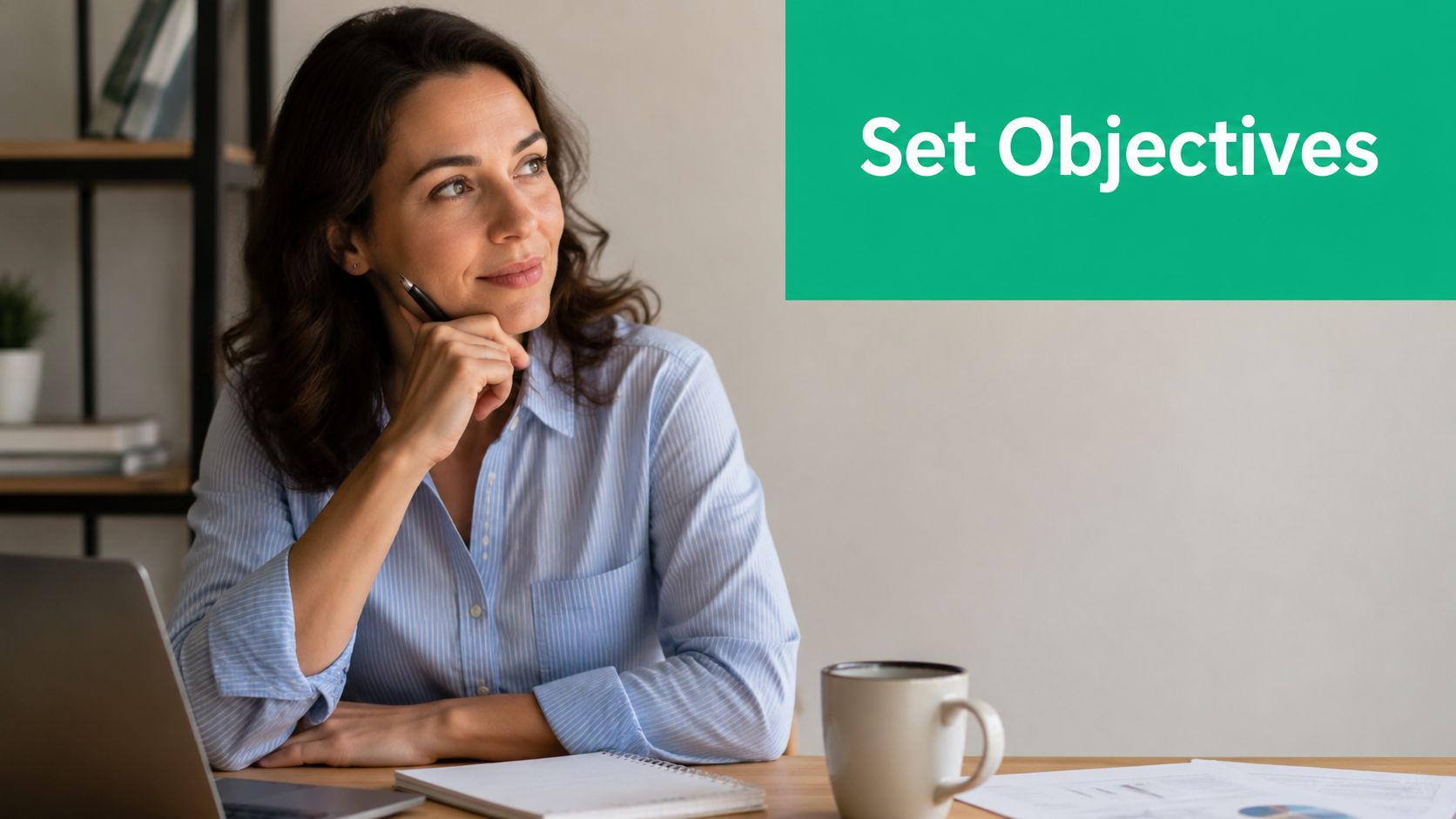 A professional woman in a blue shirt sitting at a desk and thinking while setting objectives.