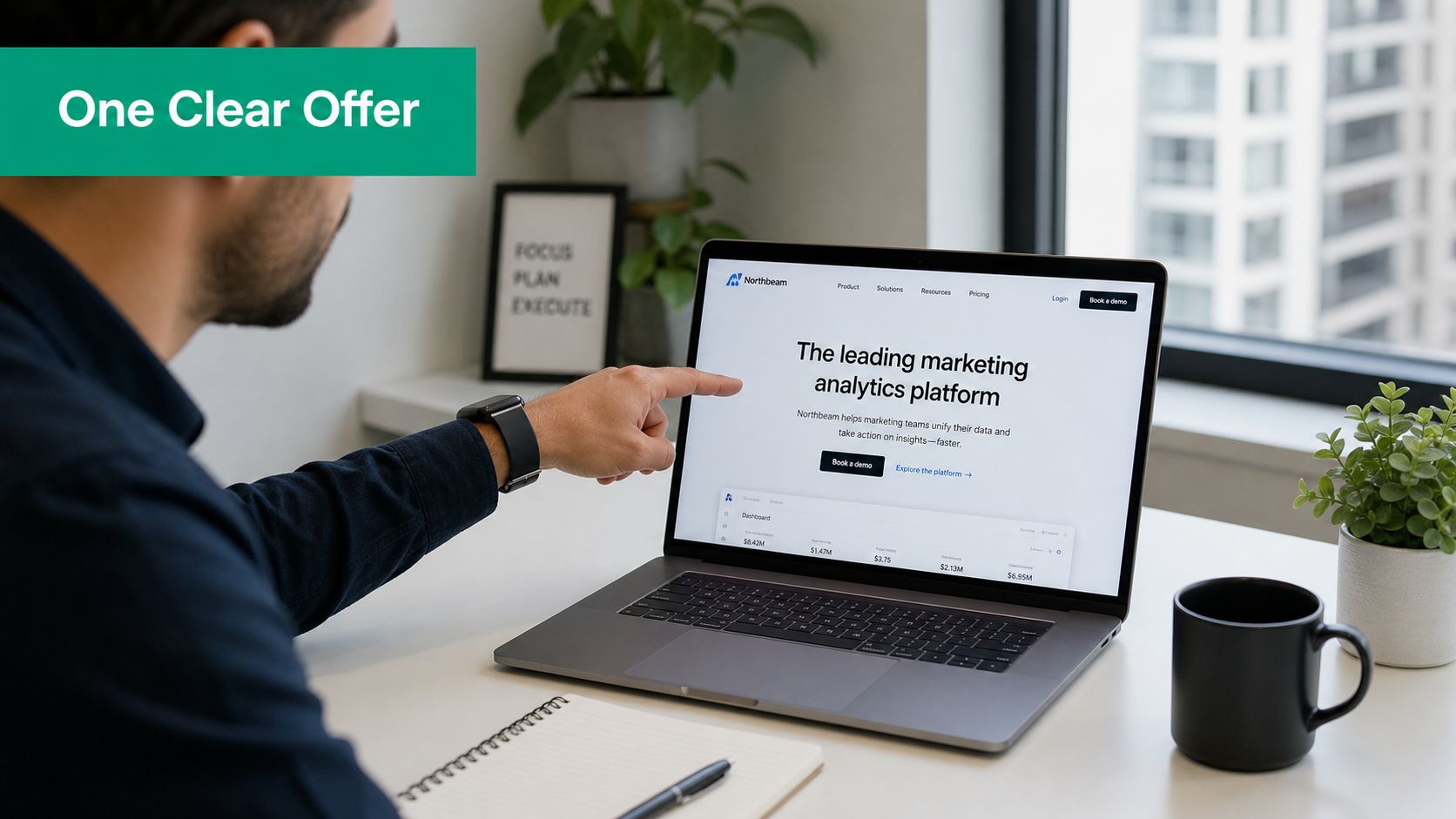 A man pointing at a laptop screen displaying a marketing analytics platform website for professional businesses.
